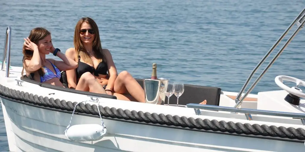 two women enjoying a hire boat from Puerto de Alcudia